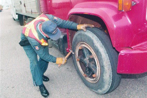 CAUGHT IN THE ACT: Be sure to perform regular tire checks and maintenance to keep your rig running smoothly so this guy doesn't have to do them.