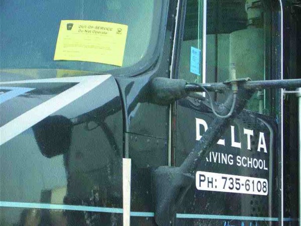 OUT OF SERVICE: A Delta tractor has a yellow Out of Service sticker displayed in its front window. The City of Calgary has permanently revoked the school's business licence.Photo by James Menzies