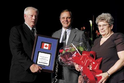 CONGRATS: Wayne Dixon (left) is presented with the CTA/Volvo Trucks Canada Driver of the Year Award. Volvo's Brent Weary presented the award while Dixon's wife Joan looks on.Photo by the OTA