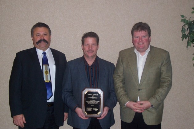 At left, Nevio Turchet of SelecTrucks of Canada presents Dave Waver and Mike Jones of TransX Group of Companies with a retention award.