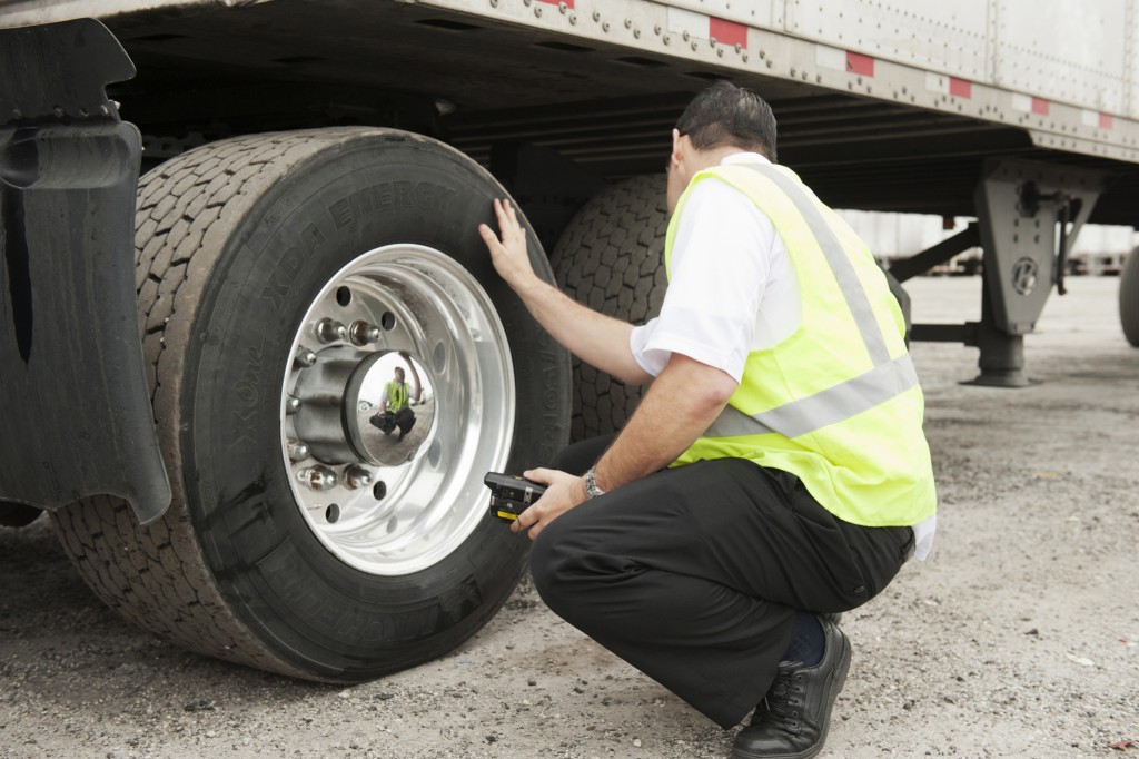 Image of a man inspecting a tire