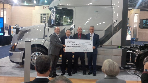 Searcy Trucking president Norm Blagden (second from right) accepts a cheque from Volvo Trucks and Michelin.