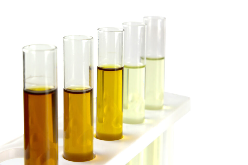 oil in glass tube isolate on white background, hydraulic oil testing in industry laboratory