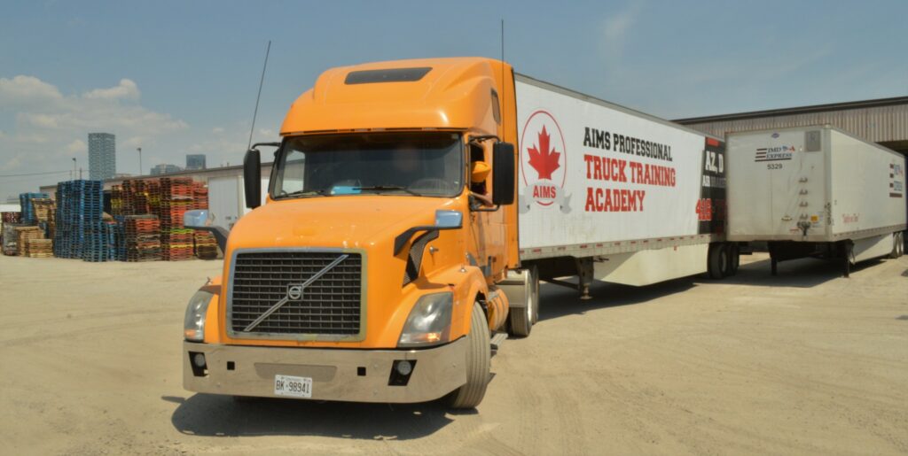 A student driver practices backing between trailers at AIMS Professional Truck Training Academy’s yard in Etobicoke, Ont. (Photo: Leo Barros)