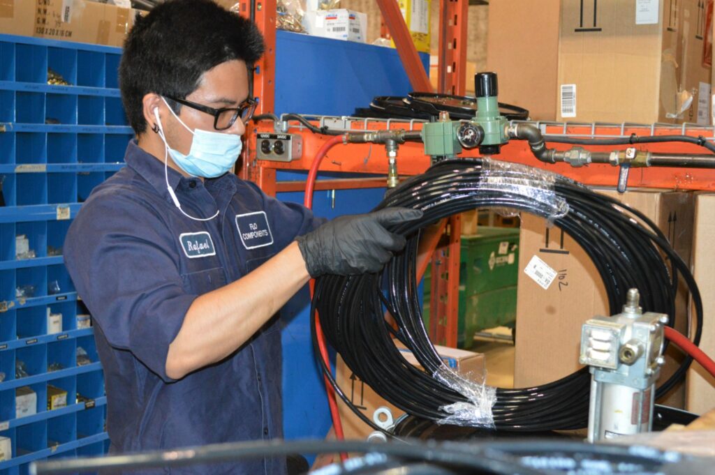 An employee works on tubing for an automated lubrication system at Flo Components in Mississauga, Ont. (Photo: Leo Barros)