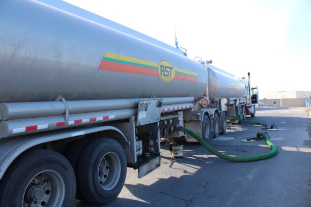 Fuel tanker unloads at fuel station