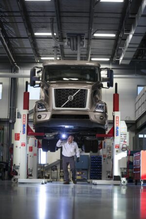 Volvo mechanic under truck