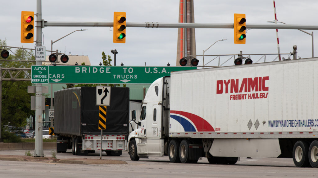 A picture of transport trucks heading toward the entrance of the Ambassador Bridge in Windsor, Ont.