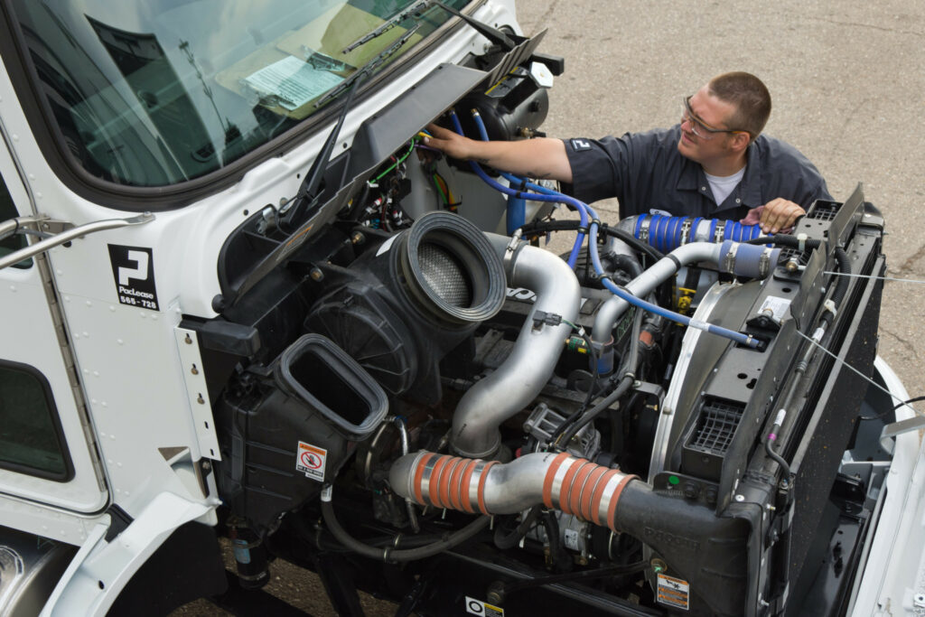 PacLease technician showing working on truck