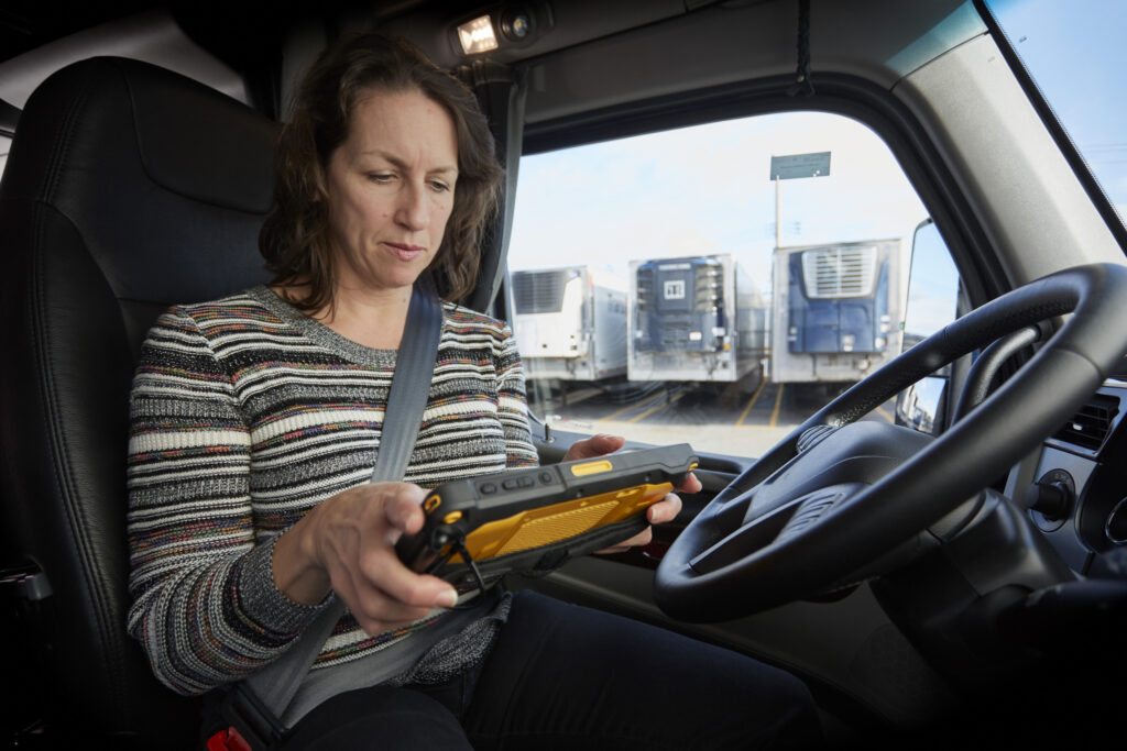 Woman looks at Isaac tablet in cab