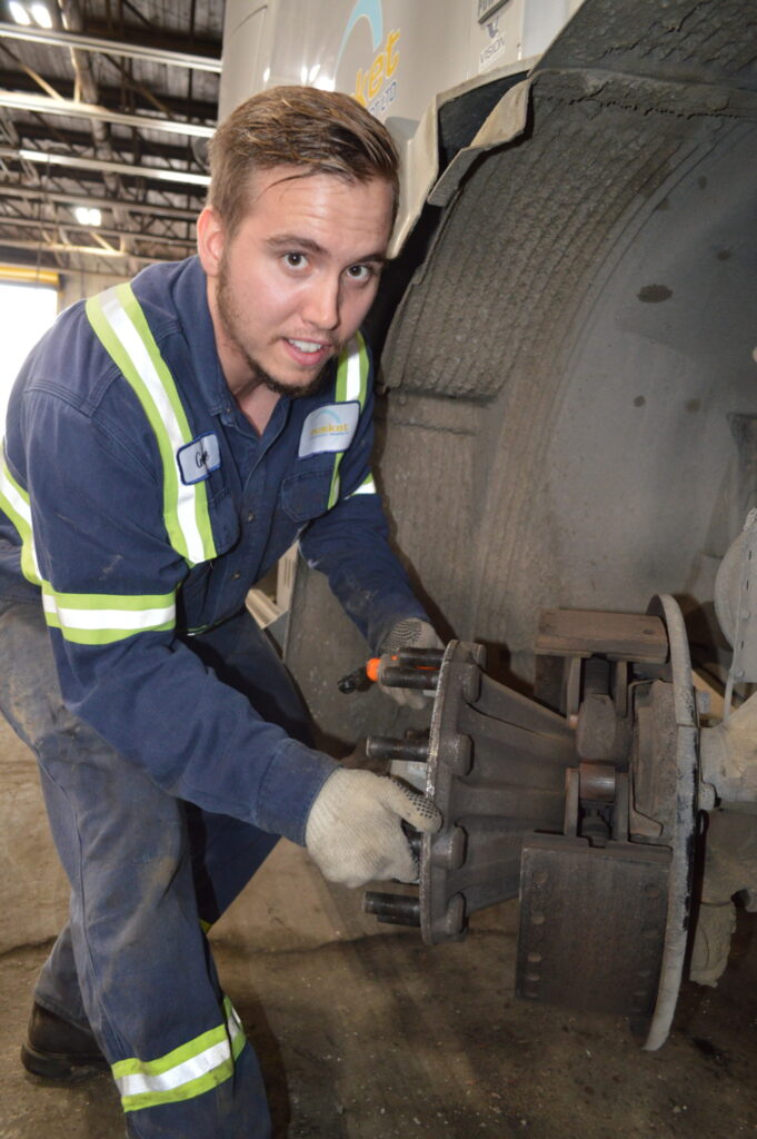 Picture of Gabe Mallory working on a truck.