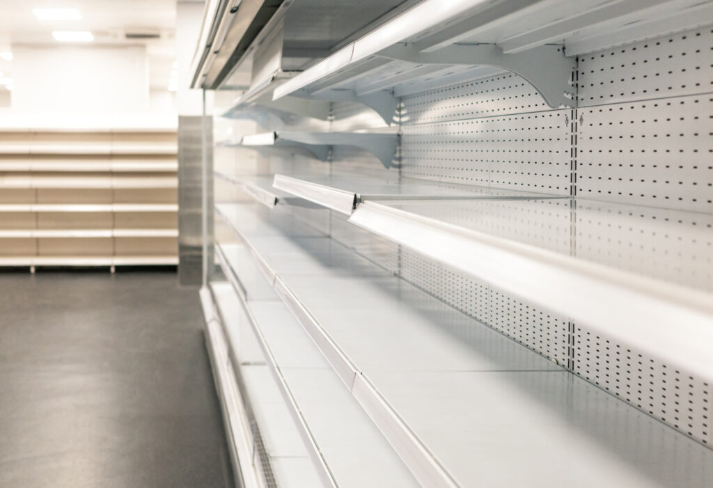 Panic buying; a series of empty shelves in a supermarket.