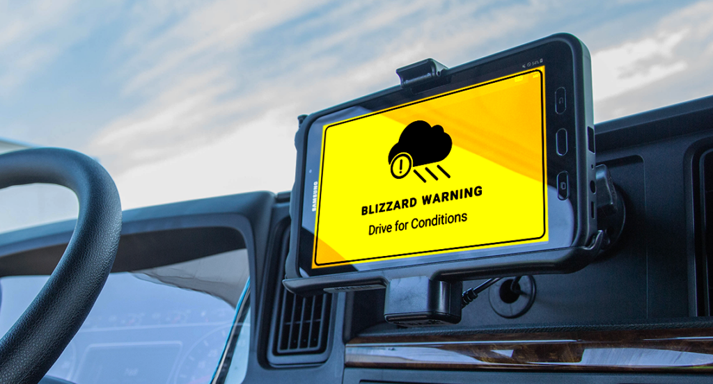 Picture of a severe weather warning issued on a device mounted on a truck's dashboard.