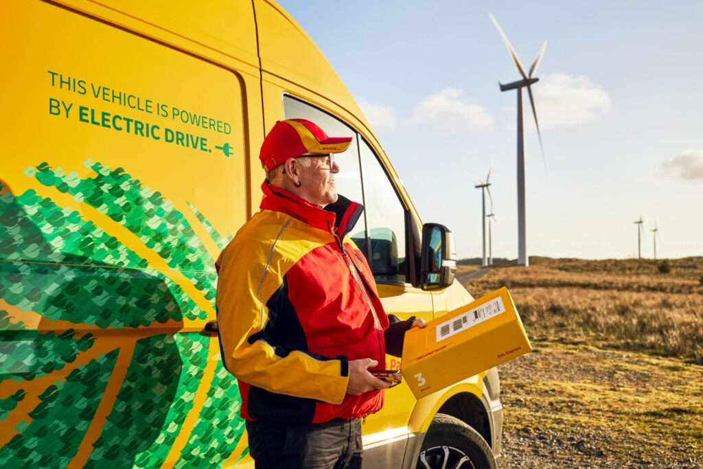Picture of DHL delivery driver and electric vehicle