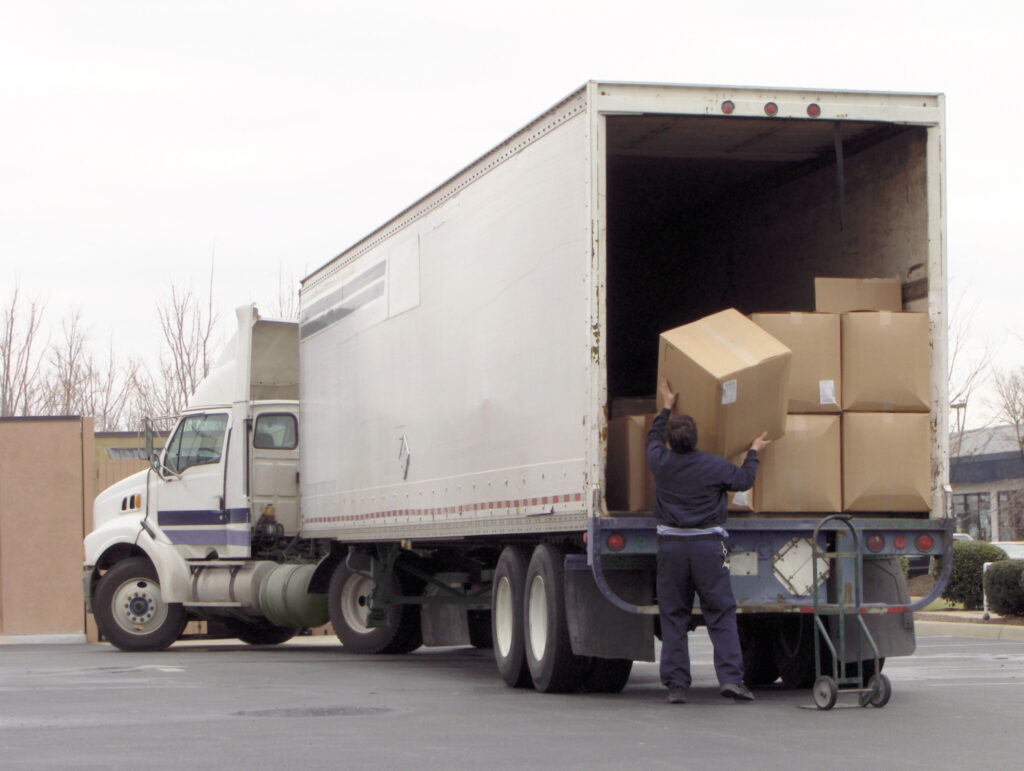 Man unloads boxes from truck