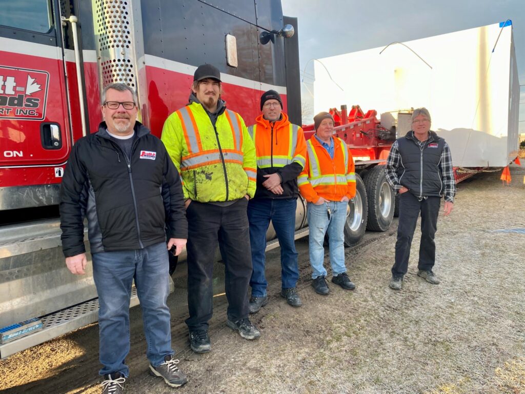 Men standing in front of a truck
