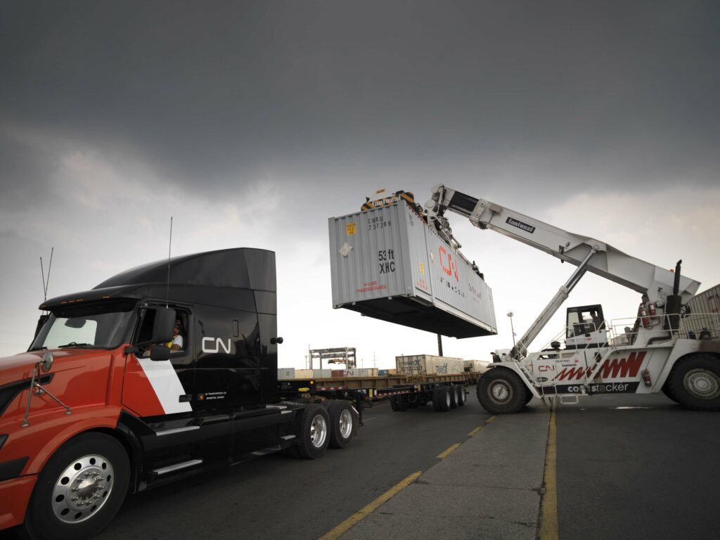 Picture of a CN truck being loaded with a container.
