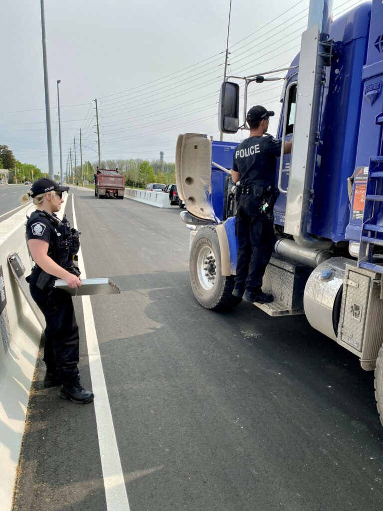 Police officers inspecting a truck