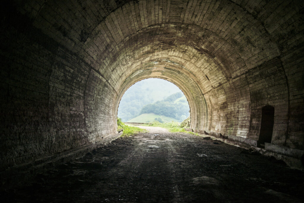 A dark tunnel with its bright exit.