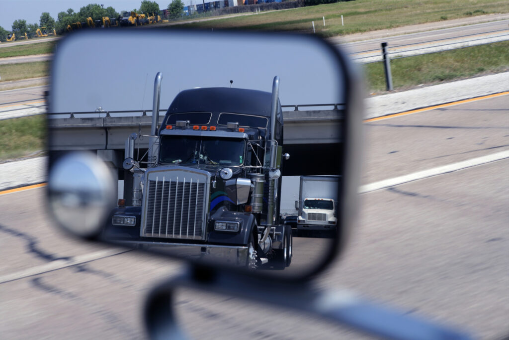 Picture of a truck in a rearview mirror