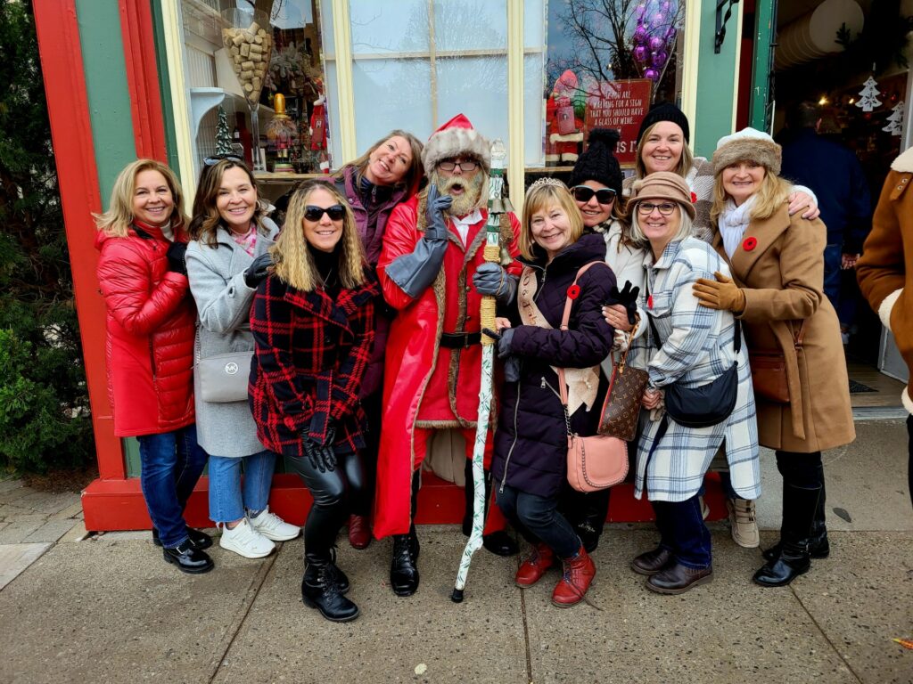 The photo is of Dave Bennison, dressed as Santa Clause, outside of a Christmas store in Niagara-on-the-Lake with a group of tourists/visitors