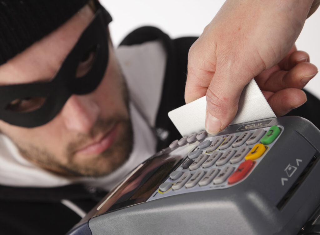 A concept image of a person having their credit card information stolen by a criminal.