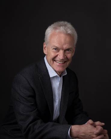 the portrait is of David Irvine, a leadership speaker who will give a speech at Trucking HR Canada's Women with Drive summit in March 2024