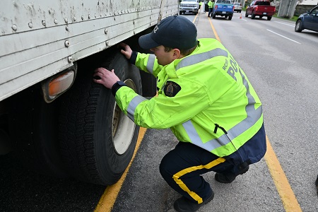 An RCMP officer inspecting a truck