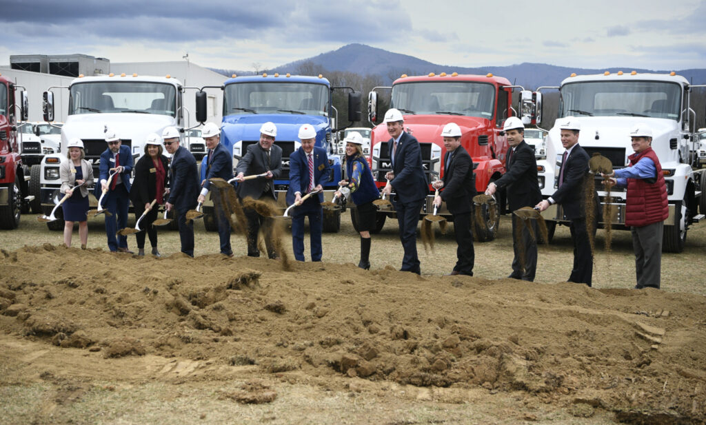 People using shovels in ground-breaking ceremony