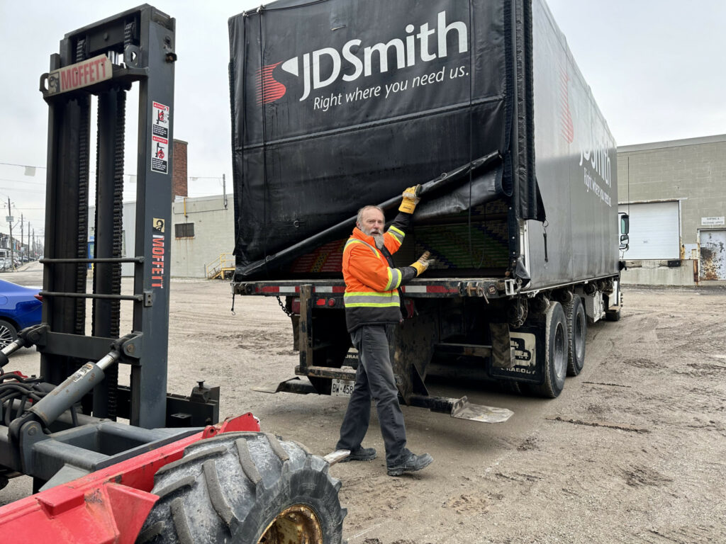 Bruce Leonard of JD Smith is in front of a delivery truck