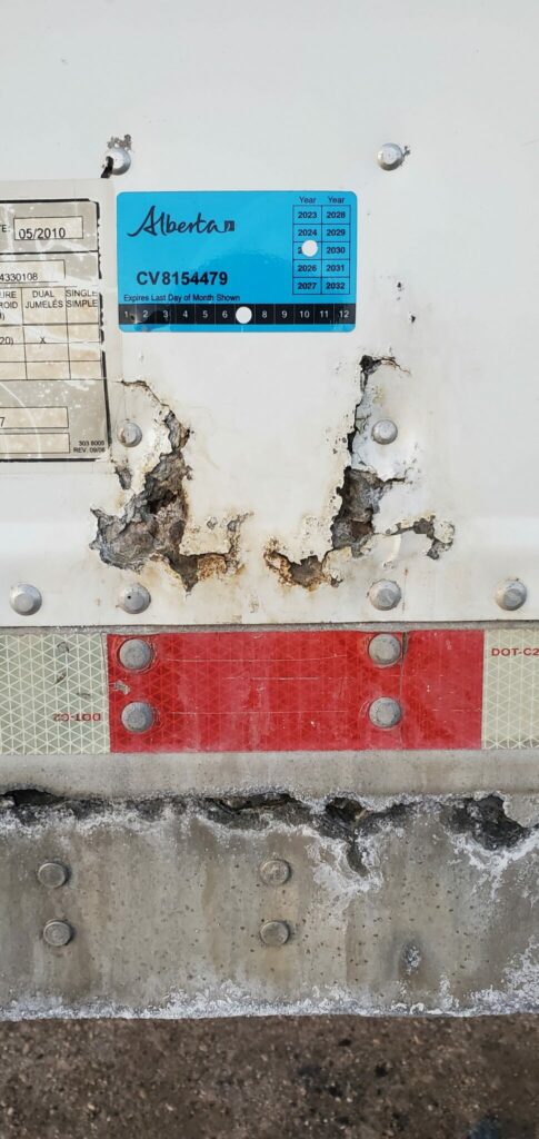 Photo of safety sticker on corroded trailer