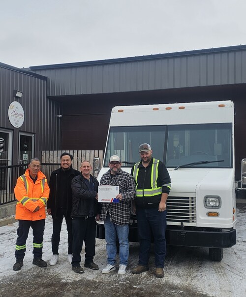A group of people on front of donated Purolator truck